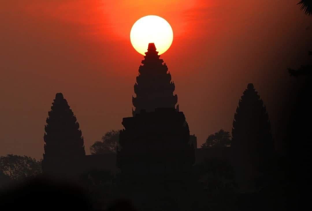 The sun rising directly over the central tower of Angkor Wat