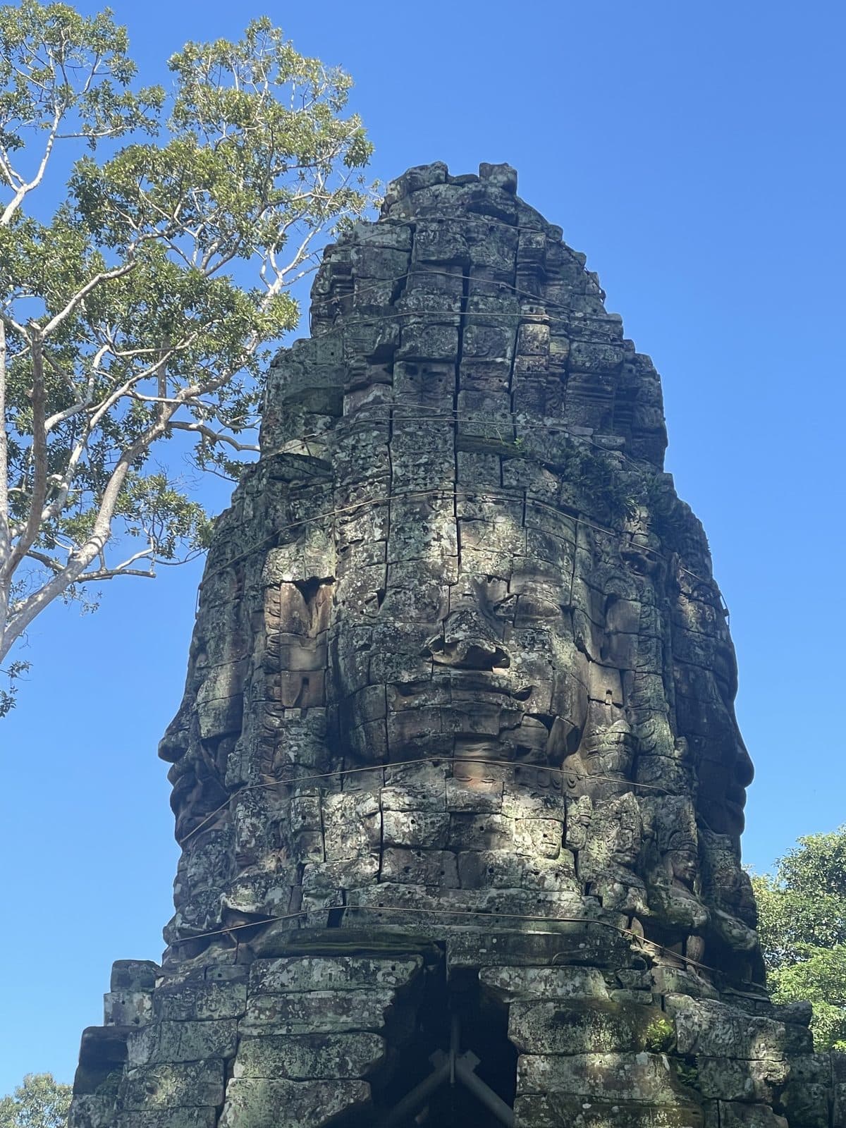 A giant carved stone face on one of the towers of the Bayon temple, Angkor Thom